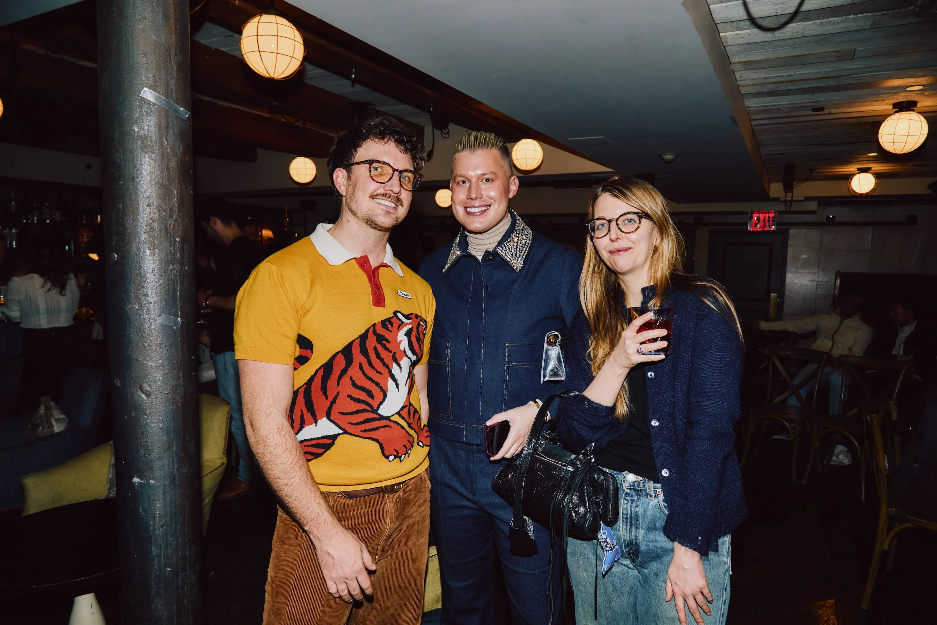 Three colleagues smiling together at an ehouse team party.