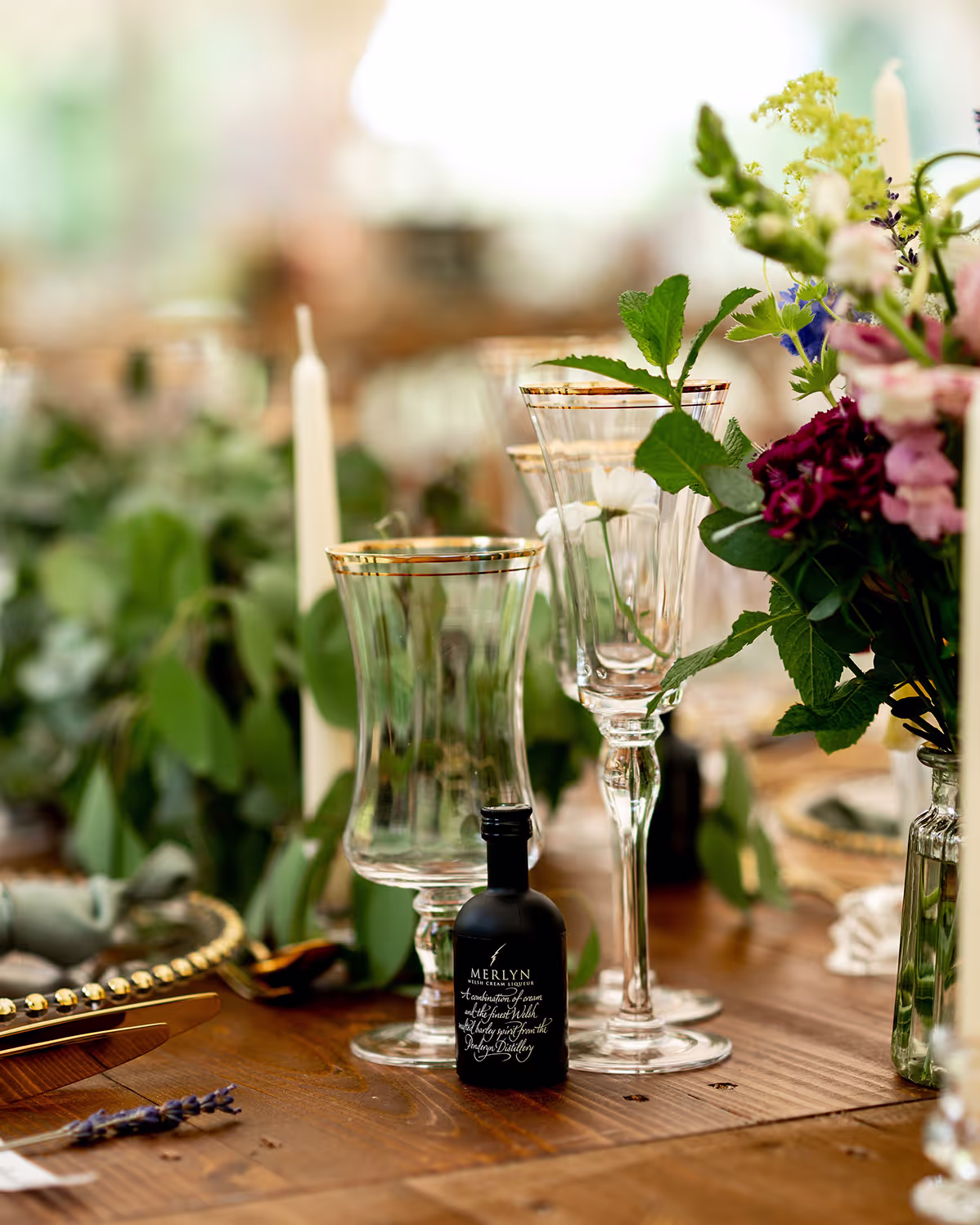 Close up of a table setting with glasses and a bespoke table favour