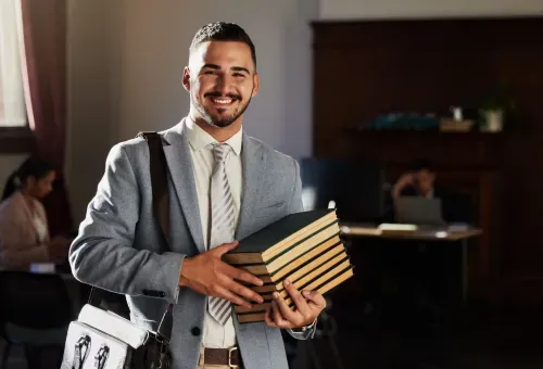A person holding a stack of books