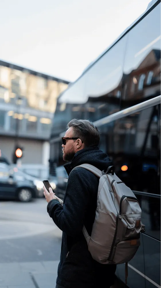 A man wearing a black jacket and carrying a backpack.