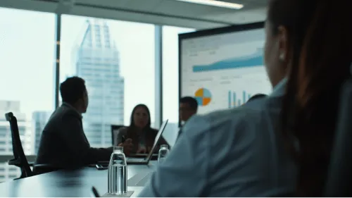 A man in a white shirt looking at a computer screen.