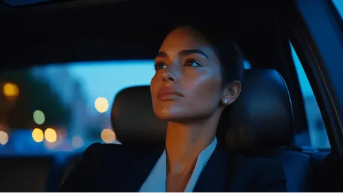 A woman in a car looking at the camera.