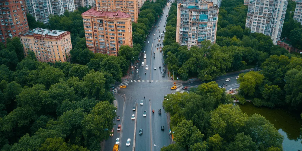 A busy city street with cars and pedestrians.
