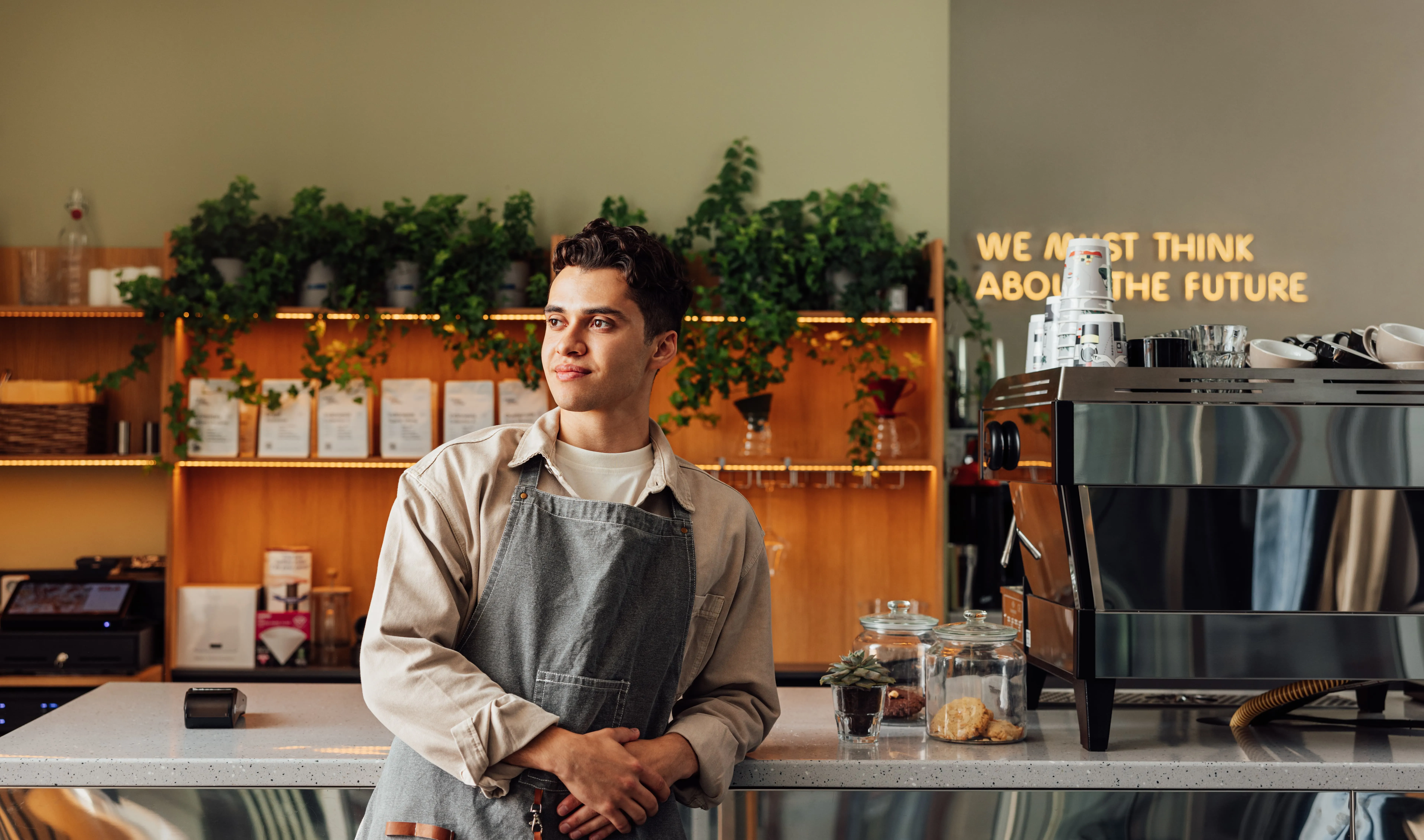 A man standing in front of a coffee machine