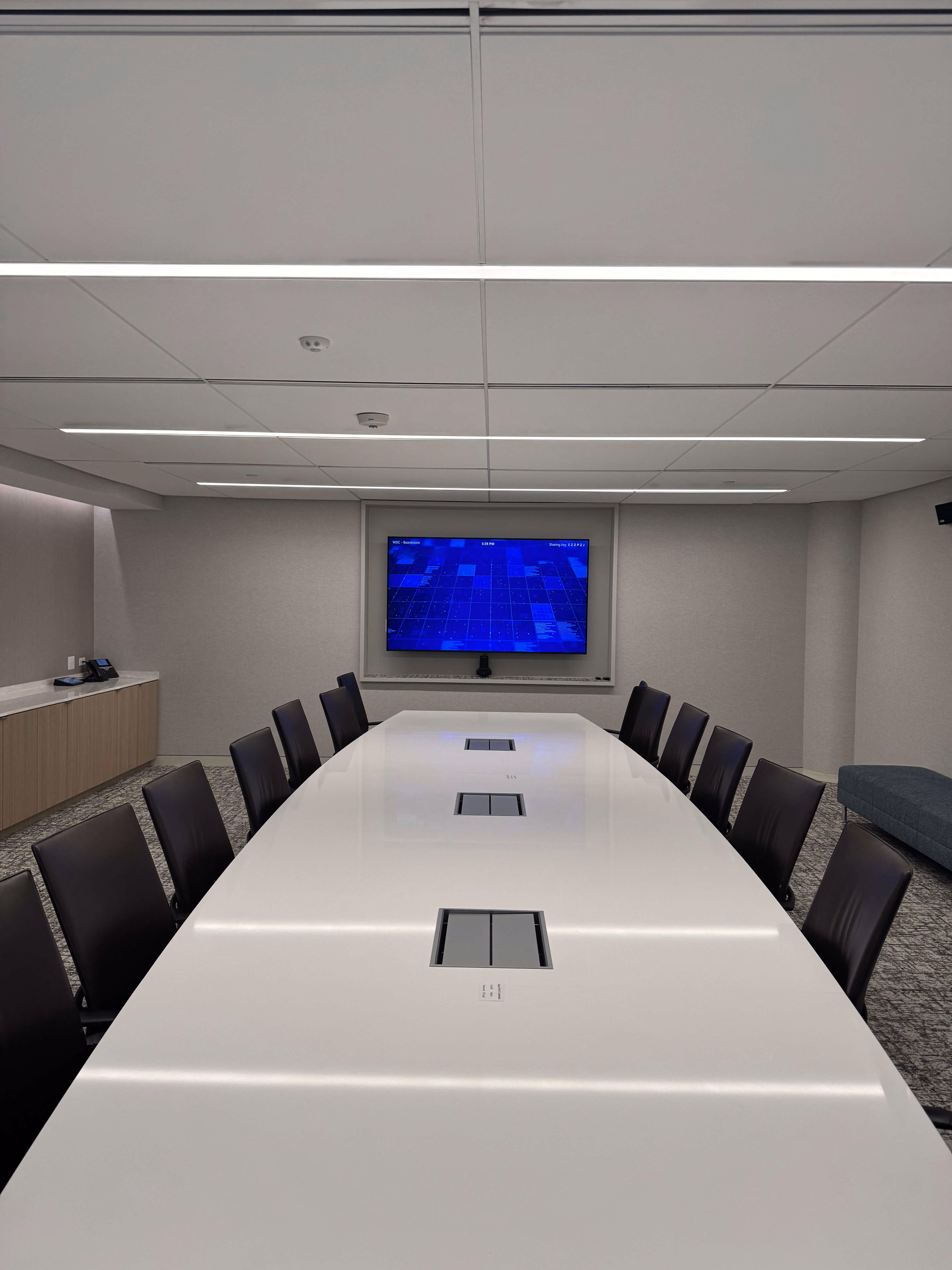 Boardroom with a wall-mounted display and long conference table