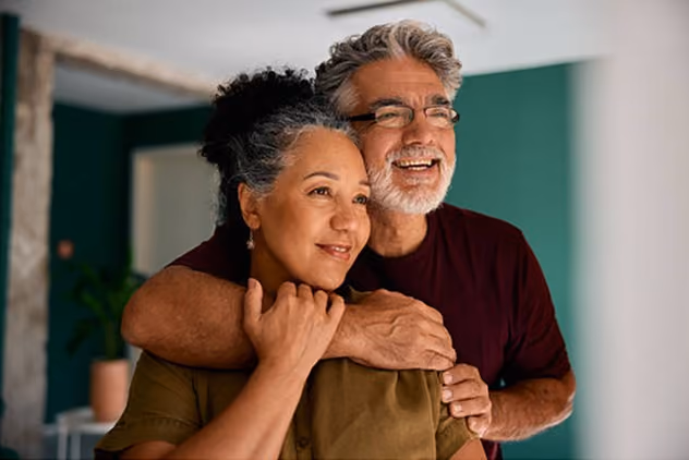 Smiling couple embracing indoors, featured alongside Northeast Wealth's contact and enquiry form