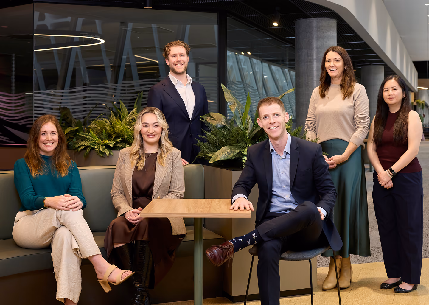 The Northeast Wealth team of financial advisors smiling together in their Melbourne office