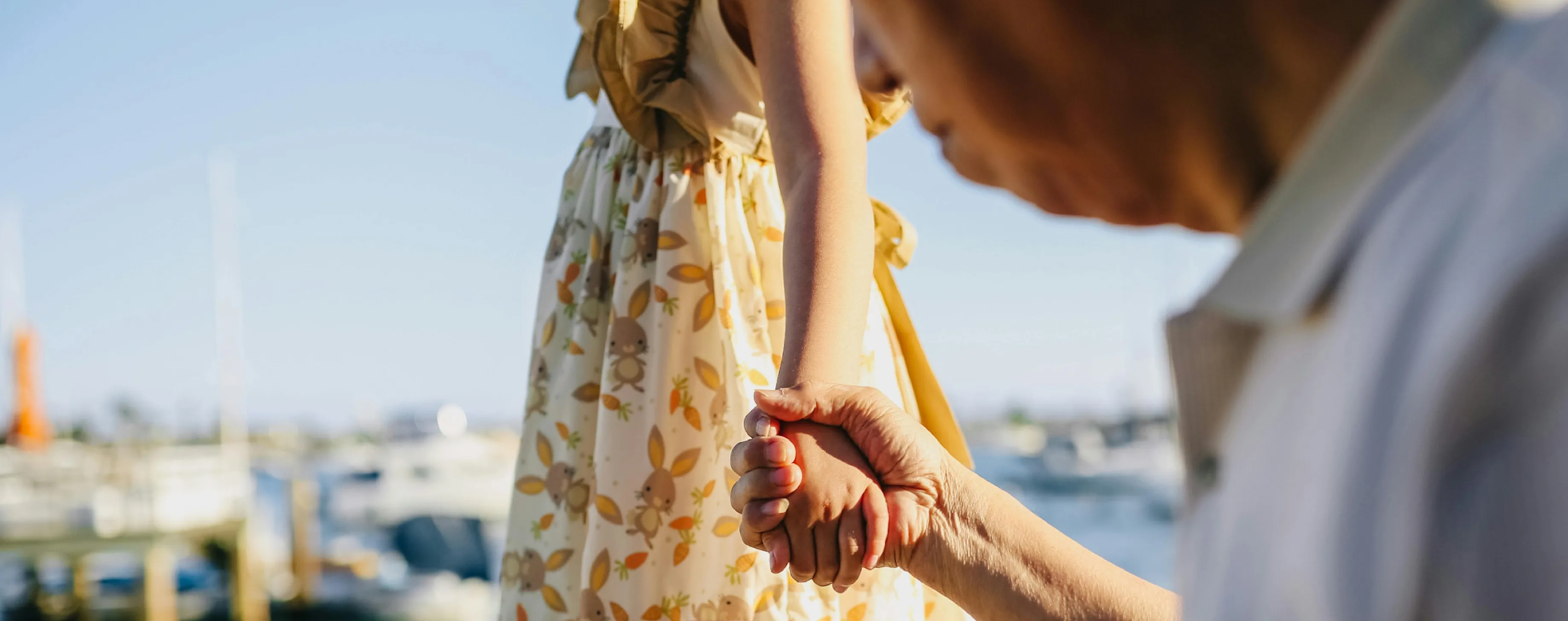 elderly person hold hands with a  young lady