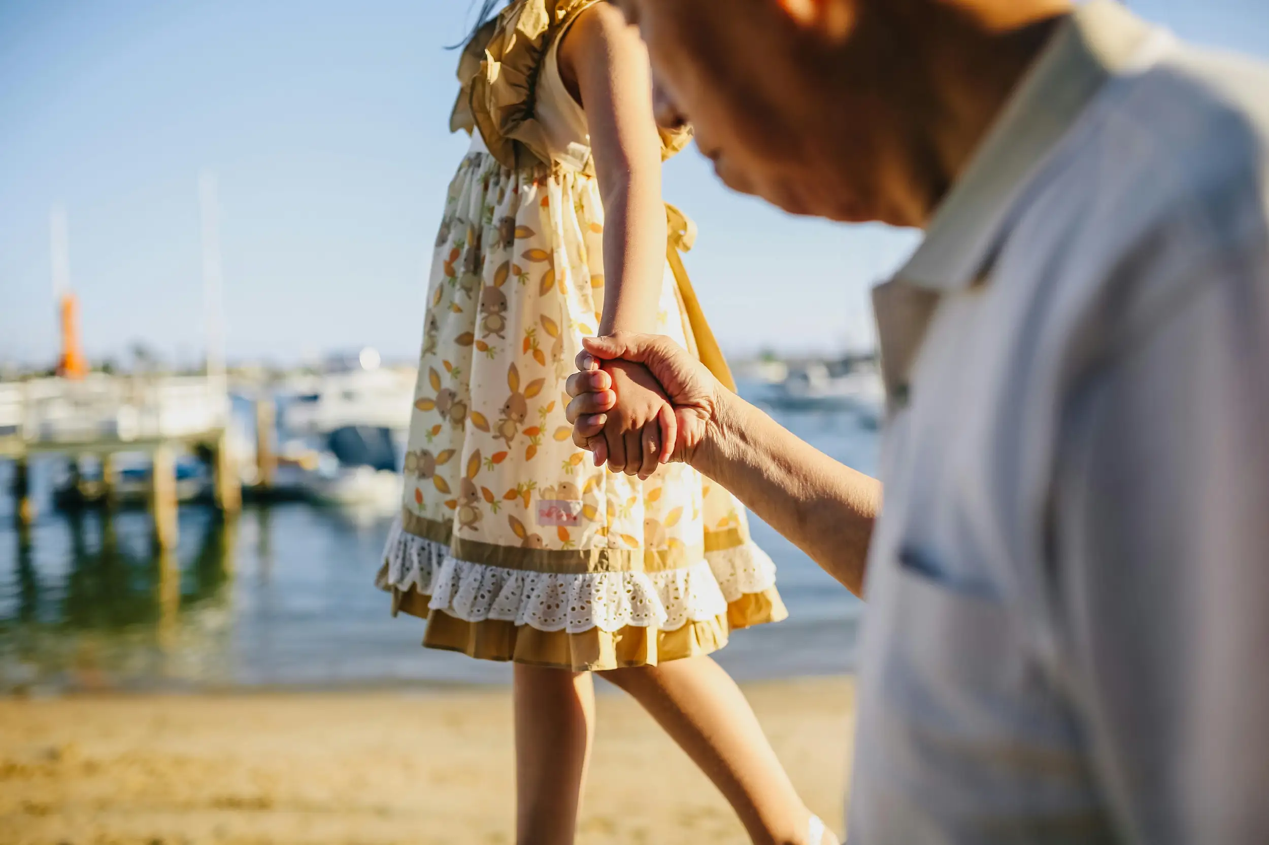 elderly person hold hands with a  young lady