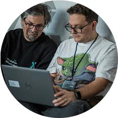 Two STX Next developers sitting in front of the computer.