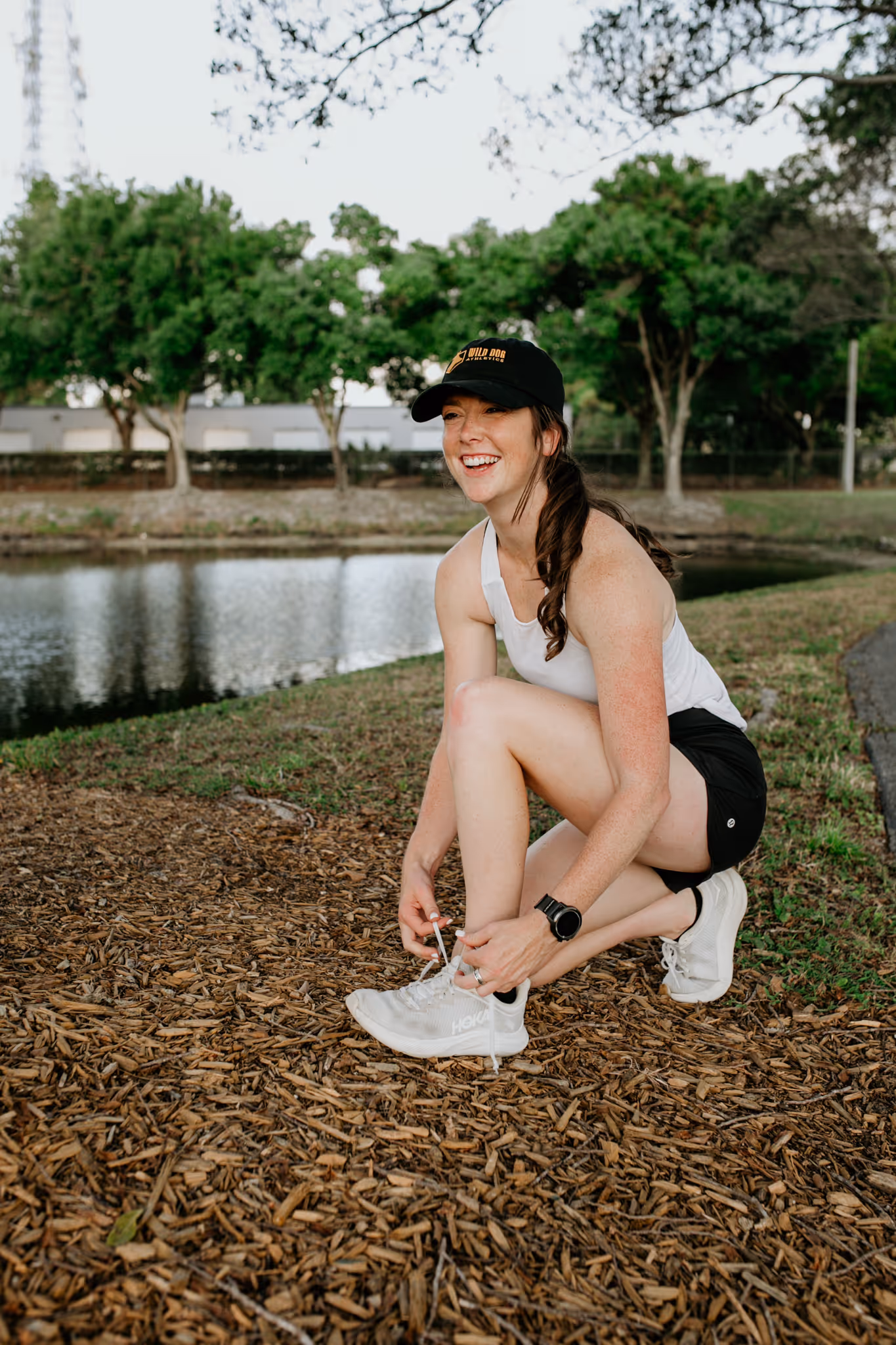Endurance running coach Abby of Wild Dog Athletics stops to tie her shoes.