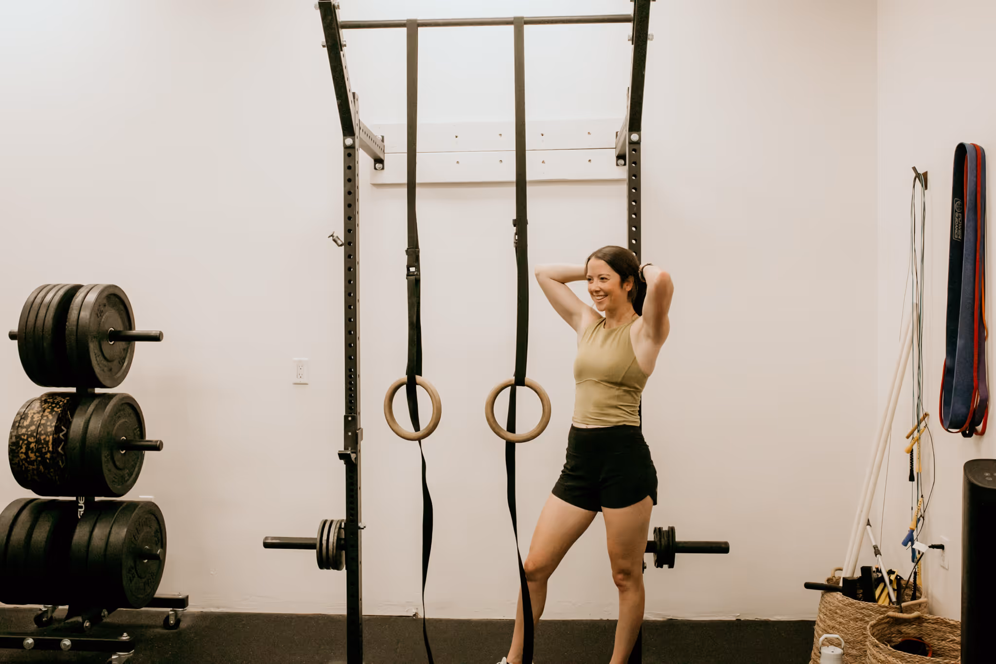 Coach Abby of Wild Dog Athletics poses in her athletic training gym.