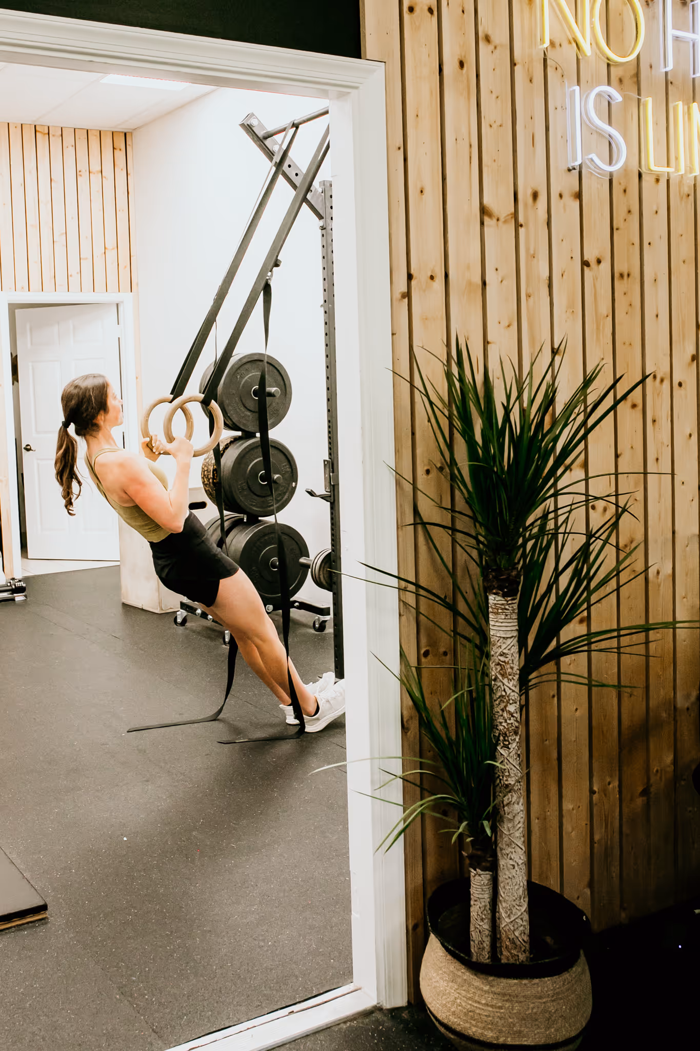 Remote athletic coach Abby of Wild Dog Athletics working out in her gym.