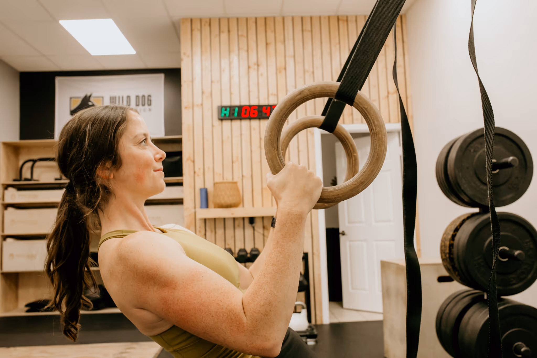 Remote athletic coach Abby of Wild Dog Athletics working out in her gym.
