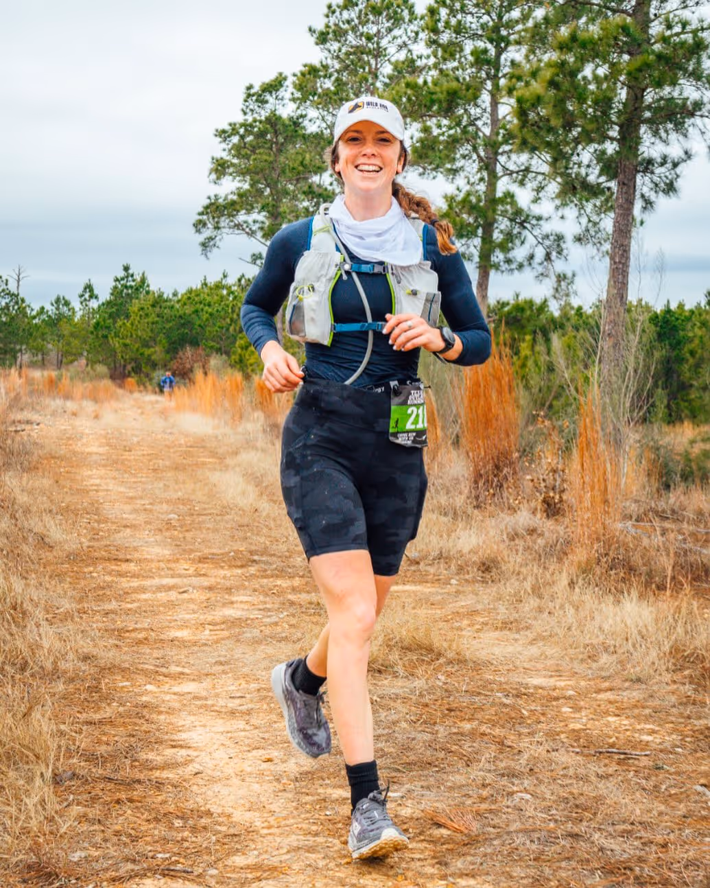 Runner mid-stride on a trail during ultra marathon training