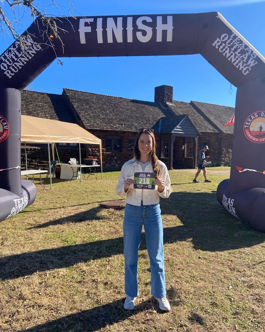 Smiling runner wearing race bib at marathon start line