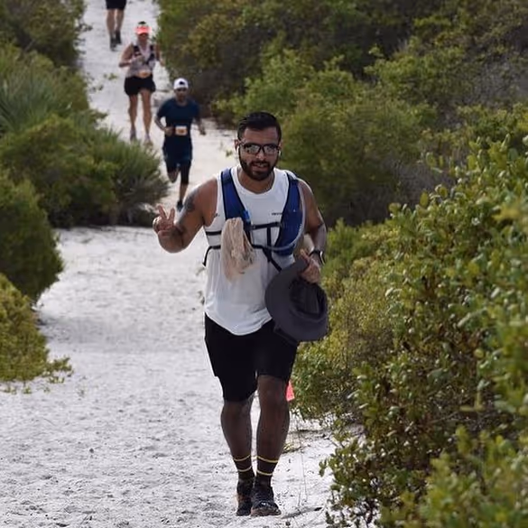 Runner mid-stride on a trail during ultra marathon training