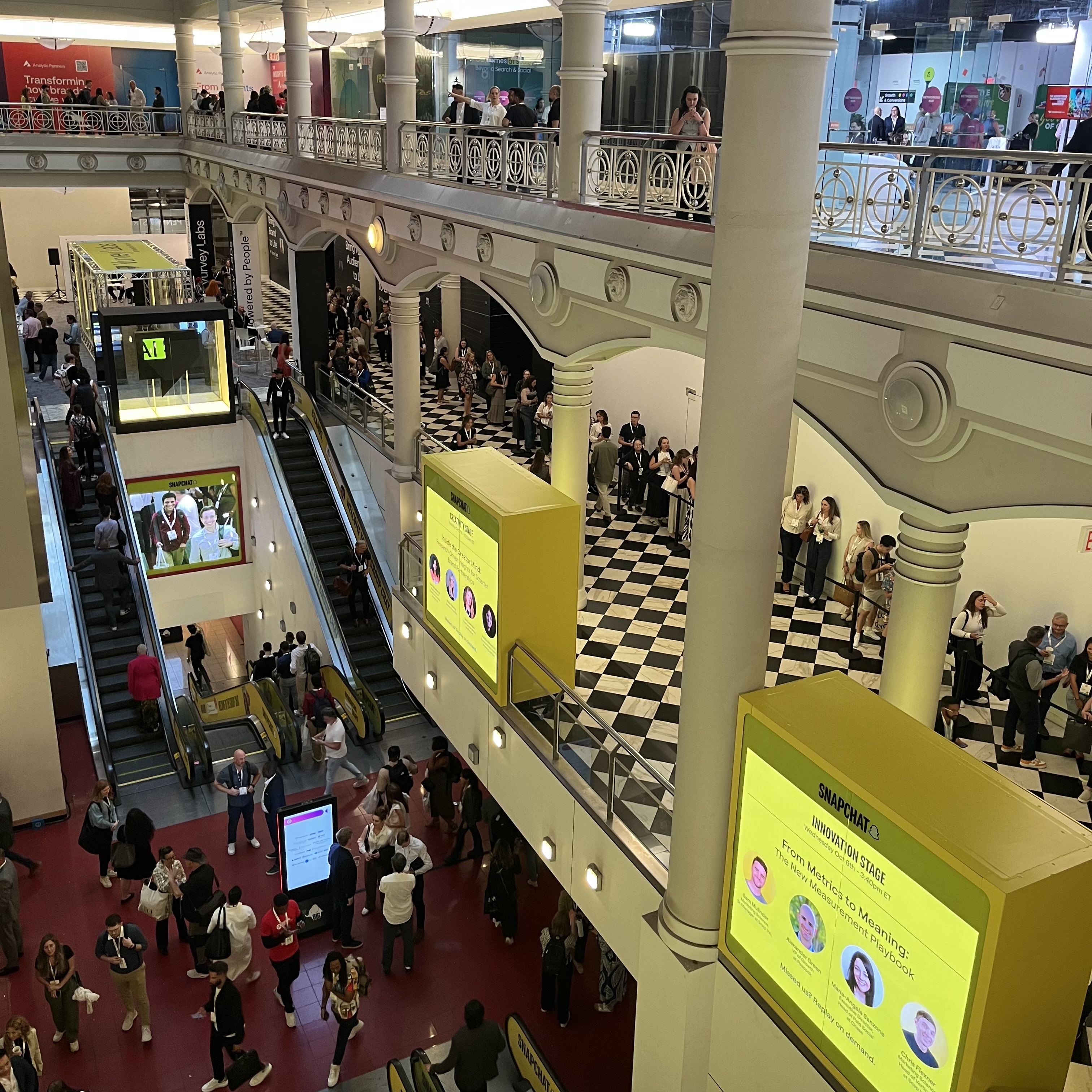 Attendees walking through the Advertising Week NYC 2025 venue with digital signage promoting innovation and AI-driven marketing sessions.
