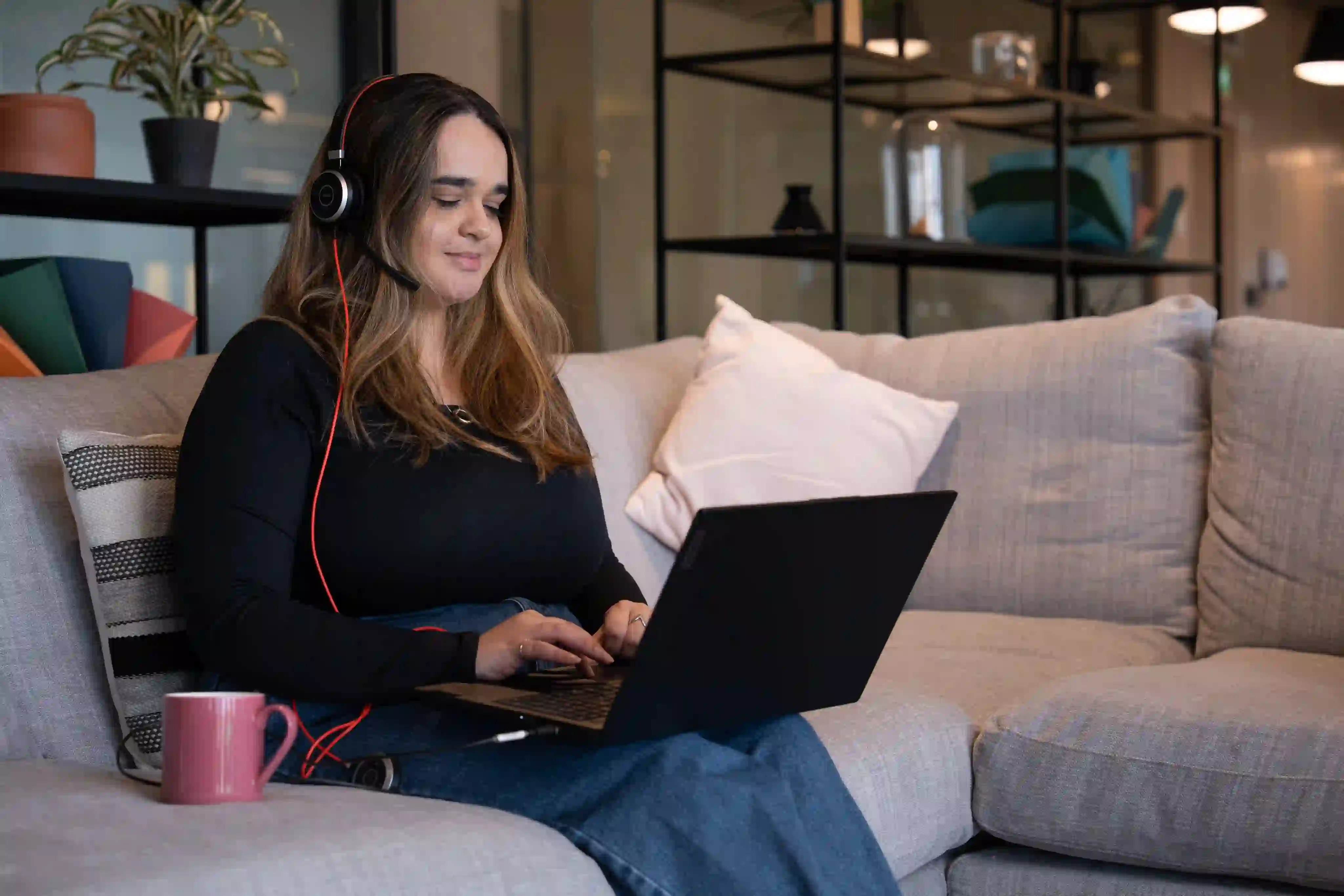 Woman working on sofa
