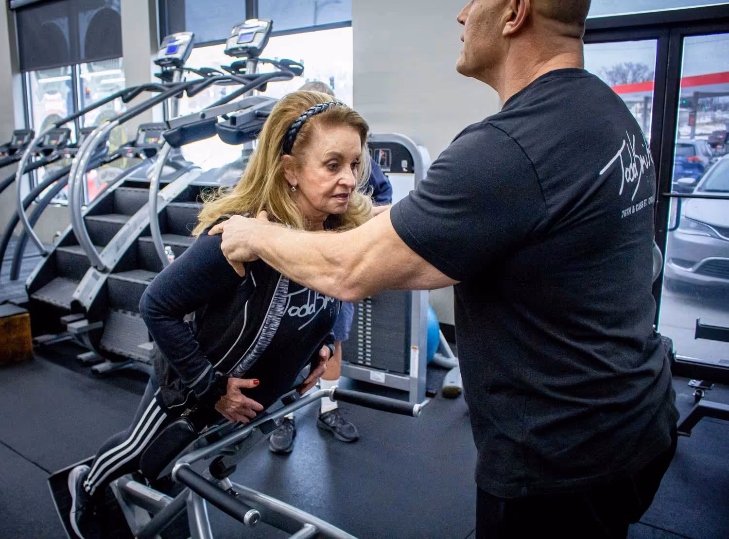 Todd Smith supporting a woman during fitness session.