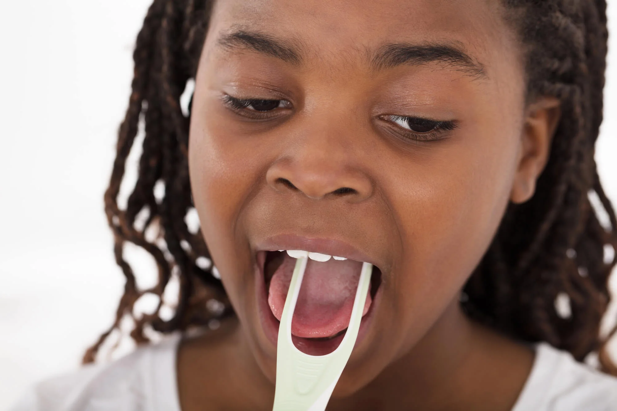 scraping tongue before seeing a Dentist in Essex CT 