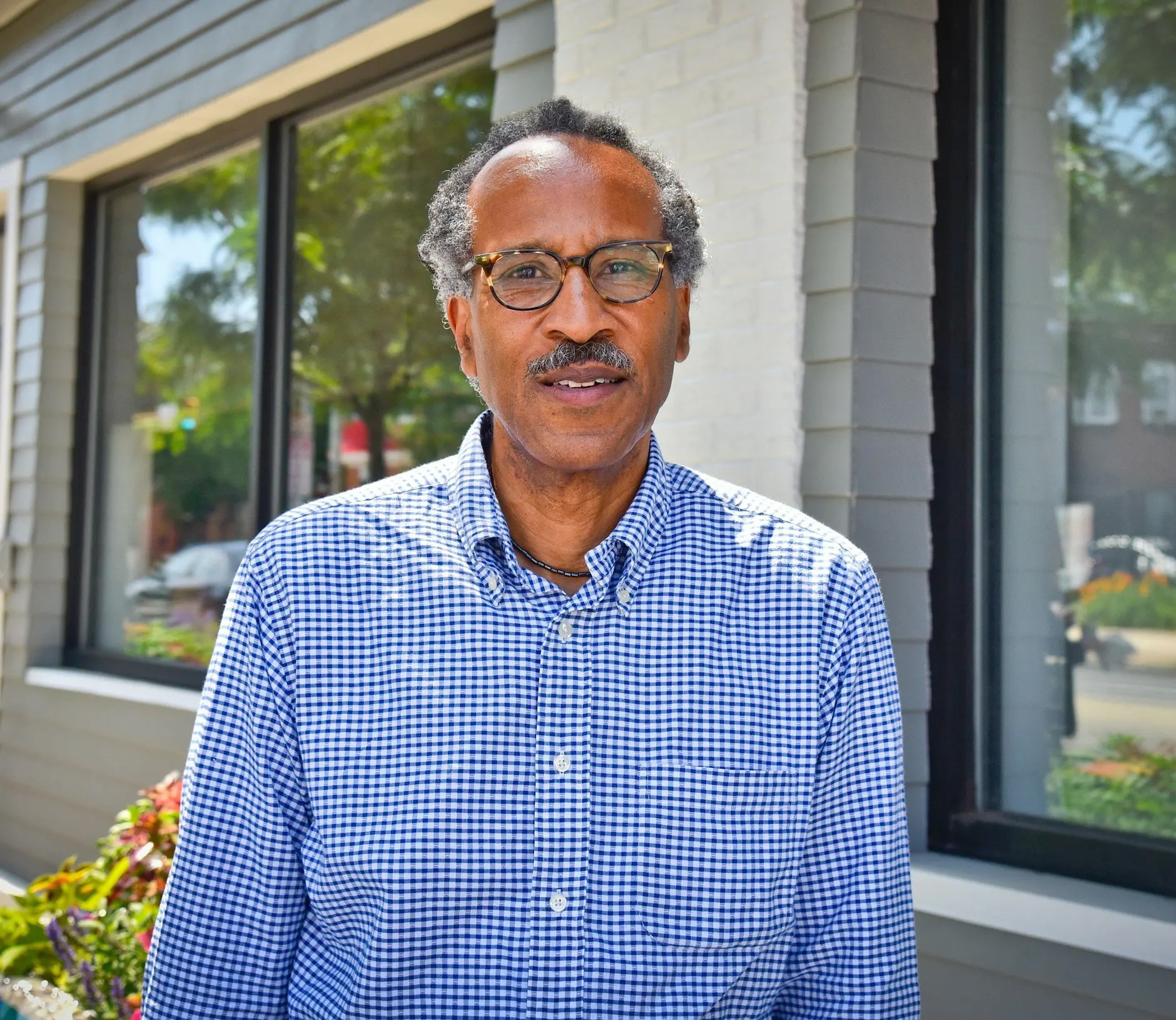 Louis Massiah in front of building