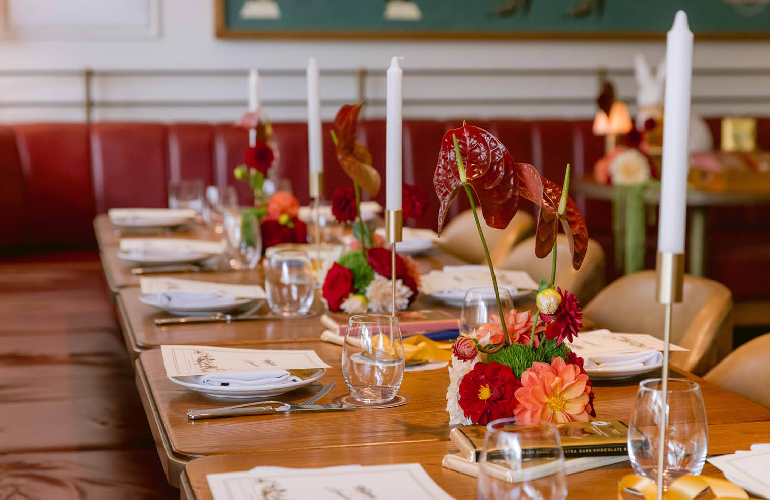 Long table set with candles and red flowers for a private event at Armorica, Surry Hills