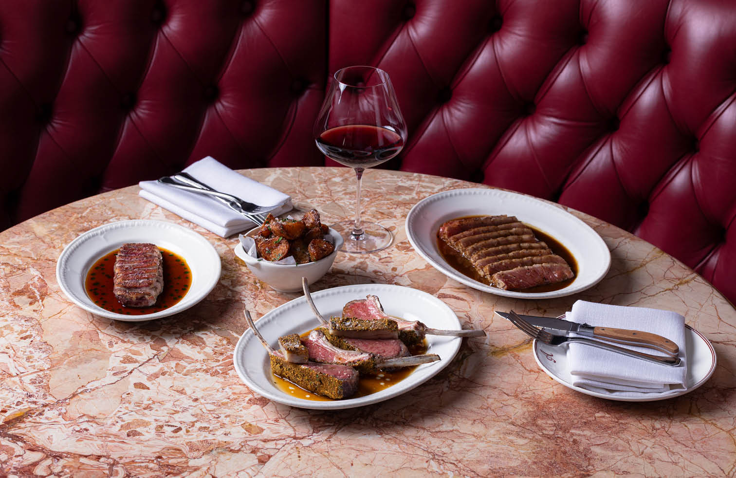 Selection of grilled steaks with jus and red wine from the menu at Armorica French brasserie