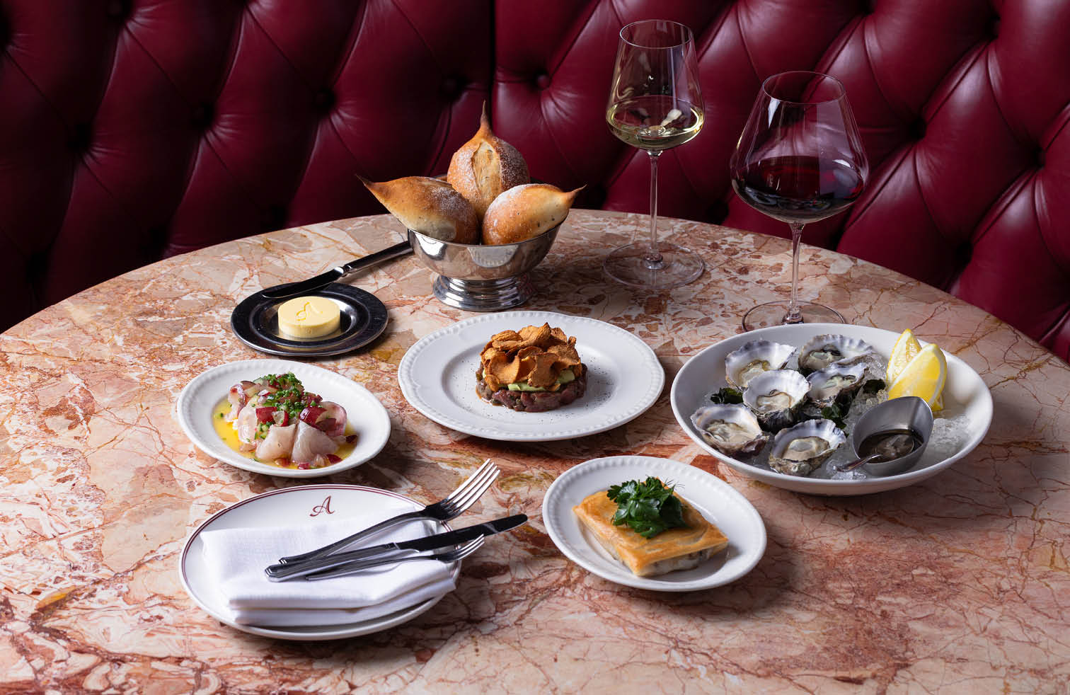 French entrées at Armorica including fresh oysters, crudo and terrine, served with bread and wine