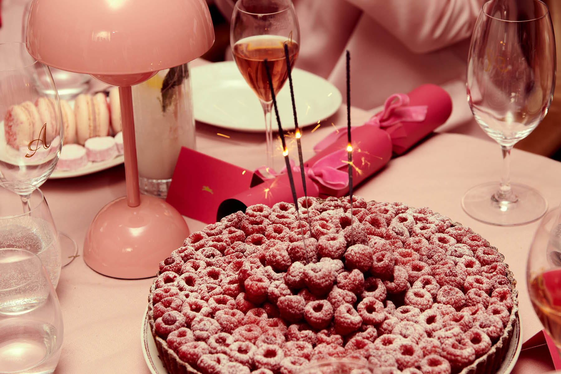 Raspberry tart with birthday candles and rosé at a celebration at Armorica French restaurant