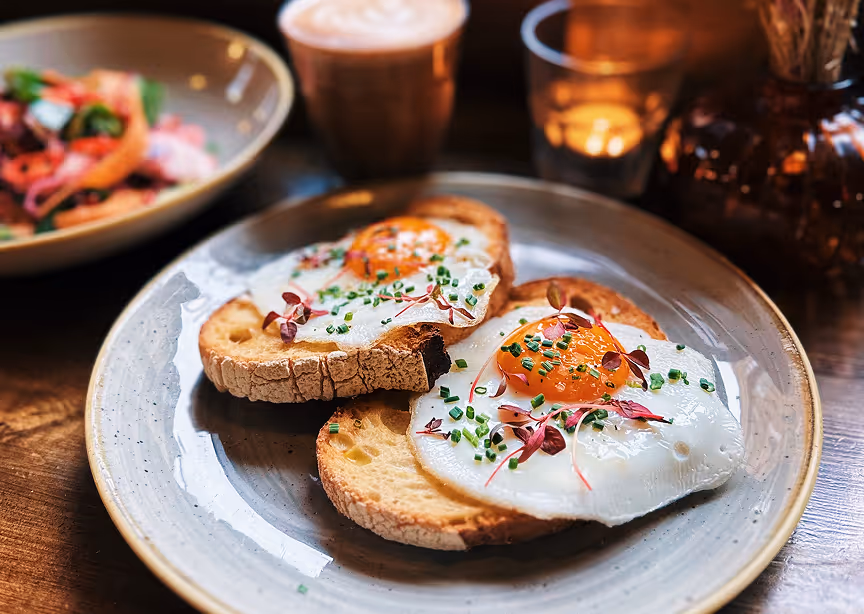 A plate with two pieces of bread topped with an egg.