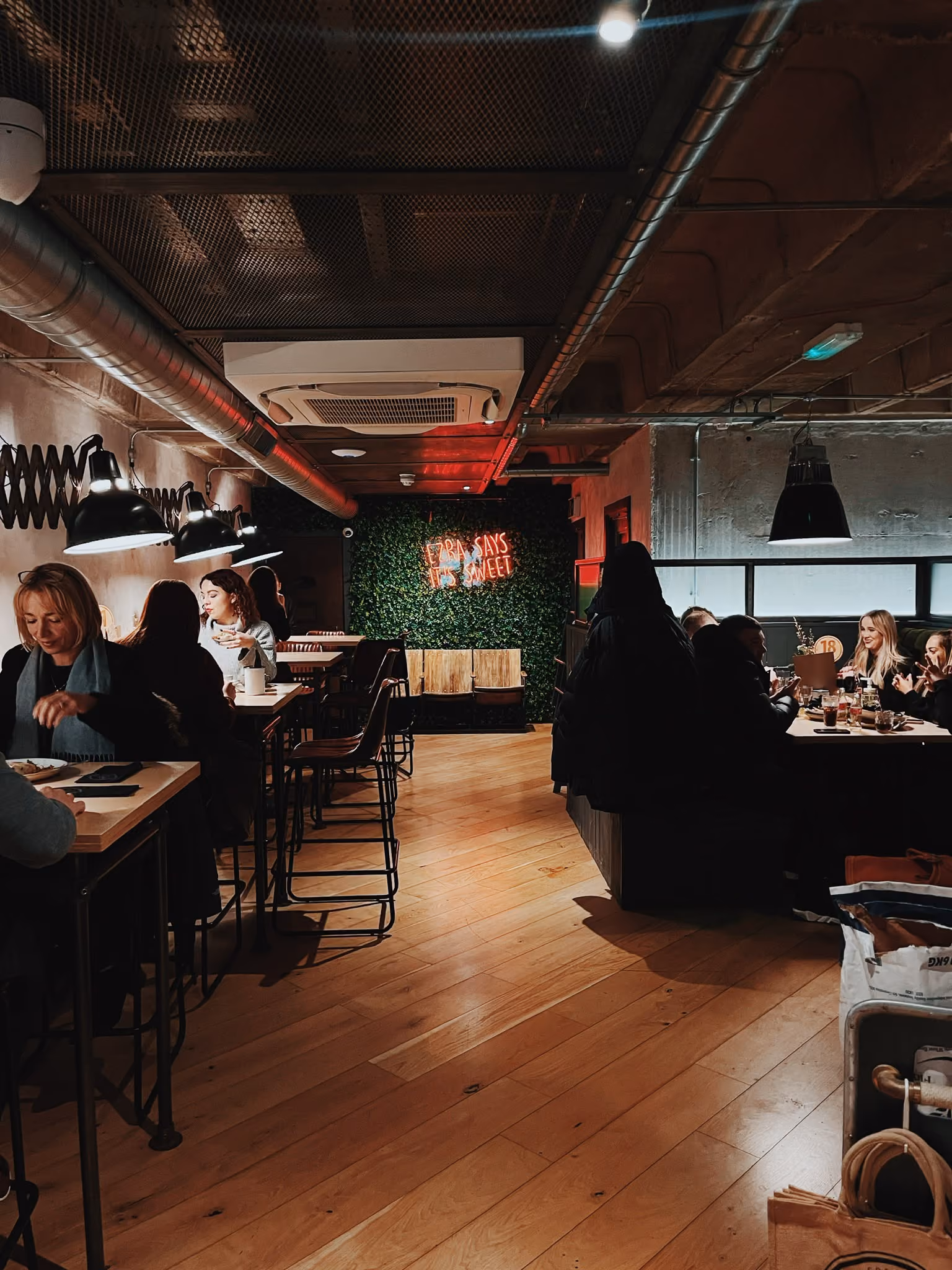 Guests dining in the busy main room at Ezra & Gil Peter Street