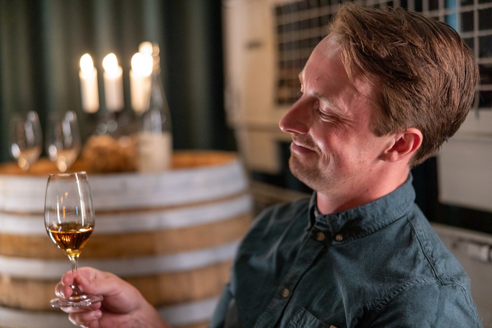 A guest looking at a glass of ice cider.