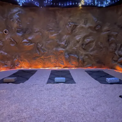 Three yoga mats laid out on a salt floor in Halo Salt Cave and Spa in Kingston, Tennessee