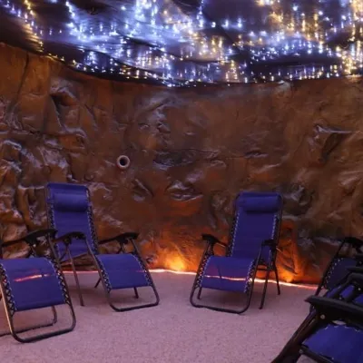 Five lounge chairs facing each other in a salt cave in Halo Salt Cave and Spa in Kingston, Tennessee