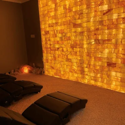 Halo Salt Spa. Inviting salt room with four beds. Beautiful salt rocks line the room as well.
