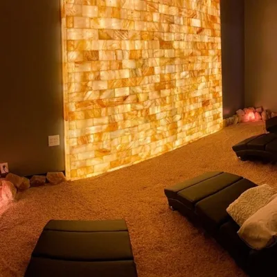 Halo Salt Spa. Inviting salt room with four beds. Beautiful salt rocks line the room as well.