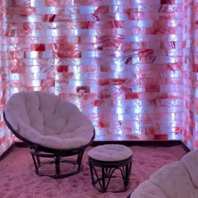 modrn sanctuary. Open salt room with chair and ottoman in the middle.