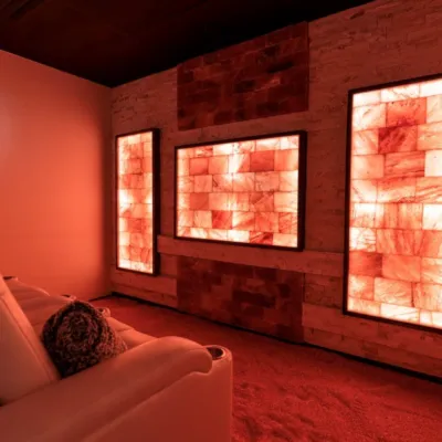 A salt therapy room with a chair and Himalayan salt bricks on a salt wall.