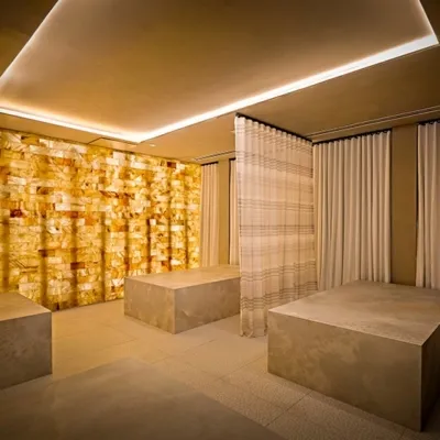 Four large rectangular smoothed granite rocks with striped separating curtains and a white backlit salt stone wall at the Solaia Condominiums in North Bergen New Jersey