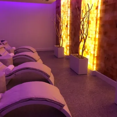 Four comfortable lounge hairs face a lit up salt wall at St. Andrews Country Club in Boca Raton, Florida