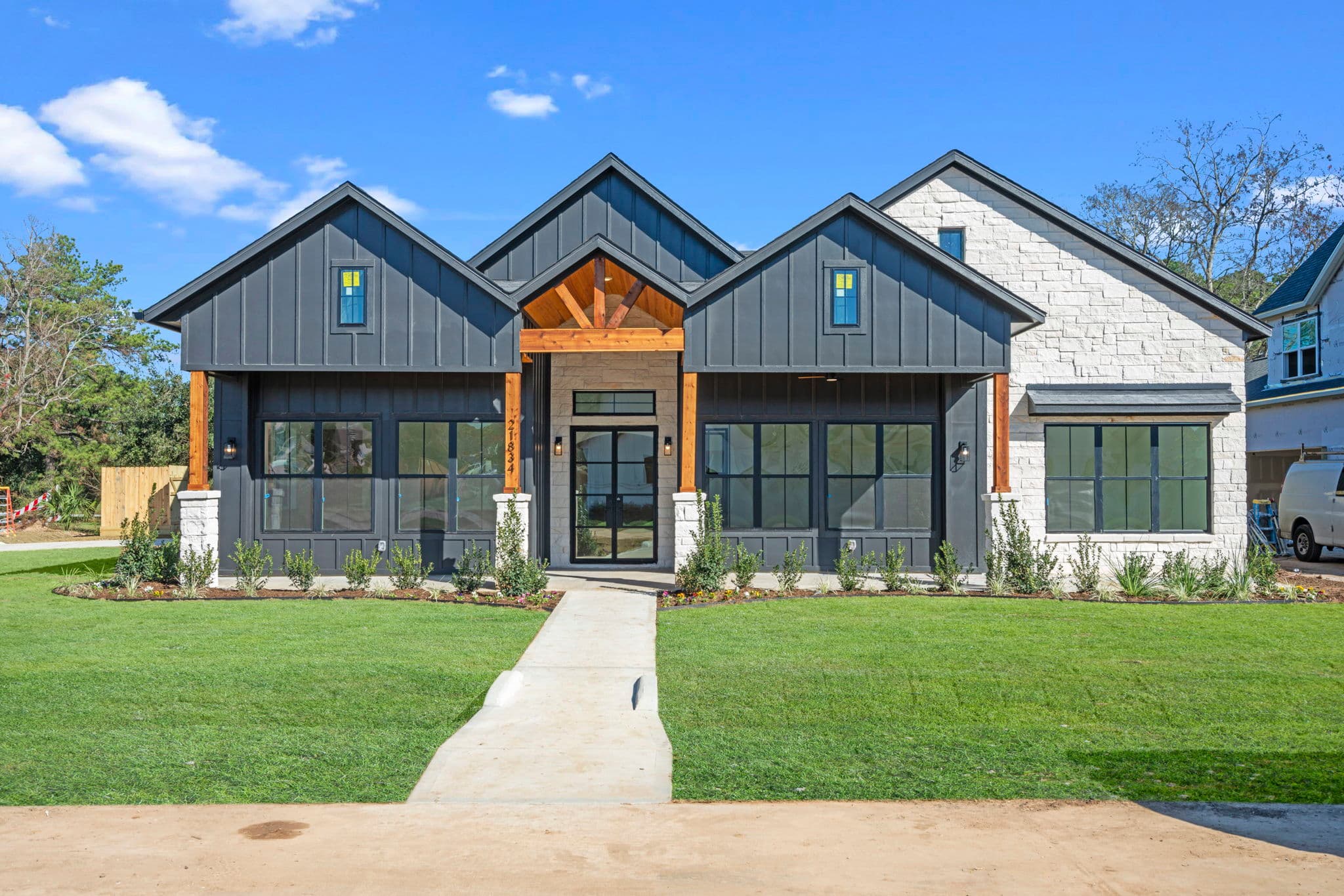 Front facade from the Financier Farmhouse. A beautiful black house on Oakview Farms.