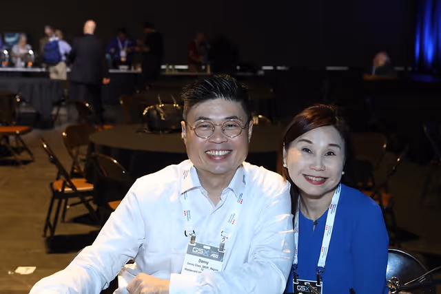 smiling male and female attendees at a previous Global Security Exchange (GSX) trade show event