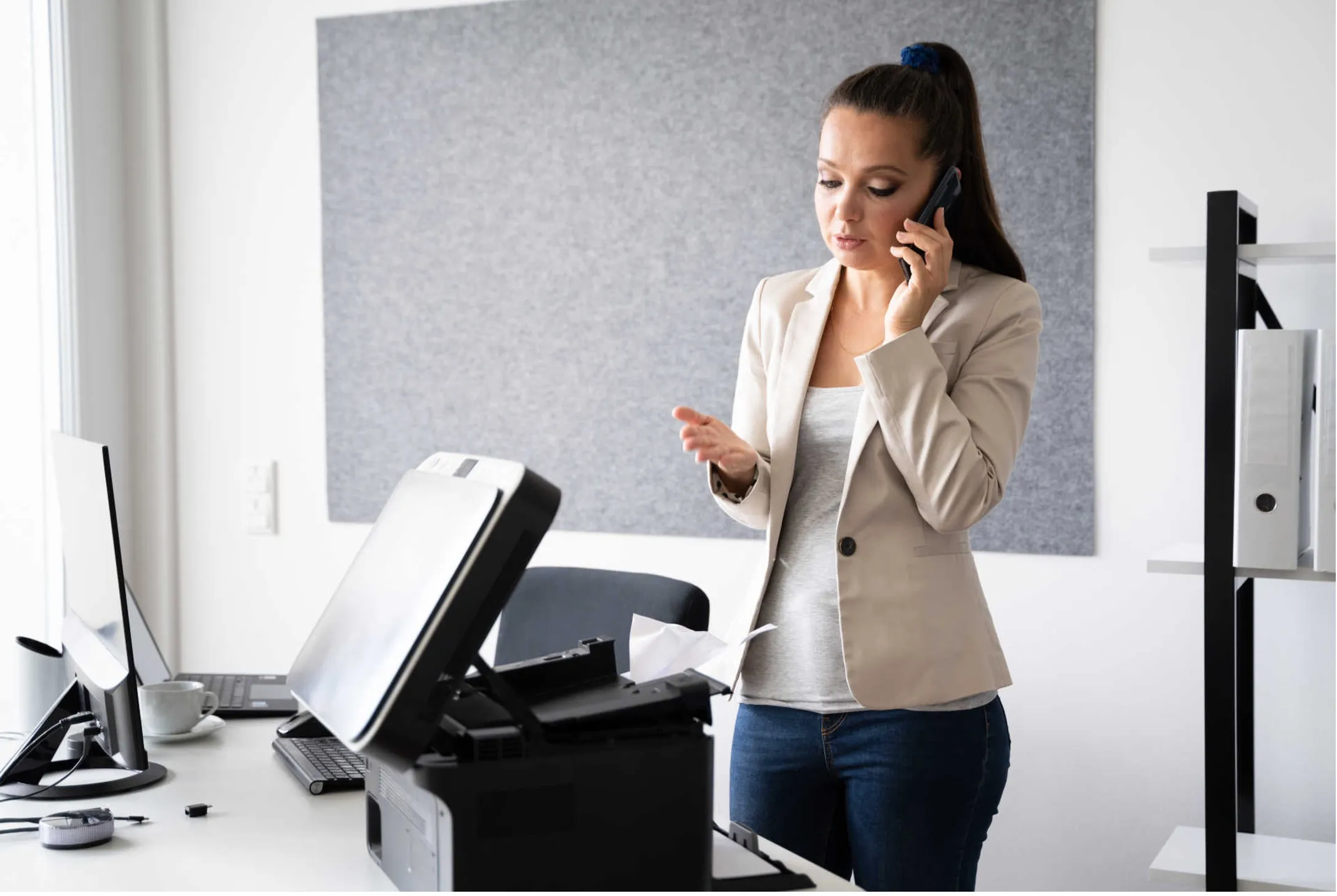 Woman trying to fix a broken printer