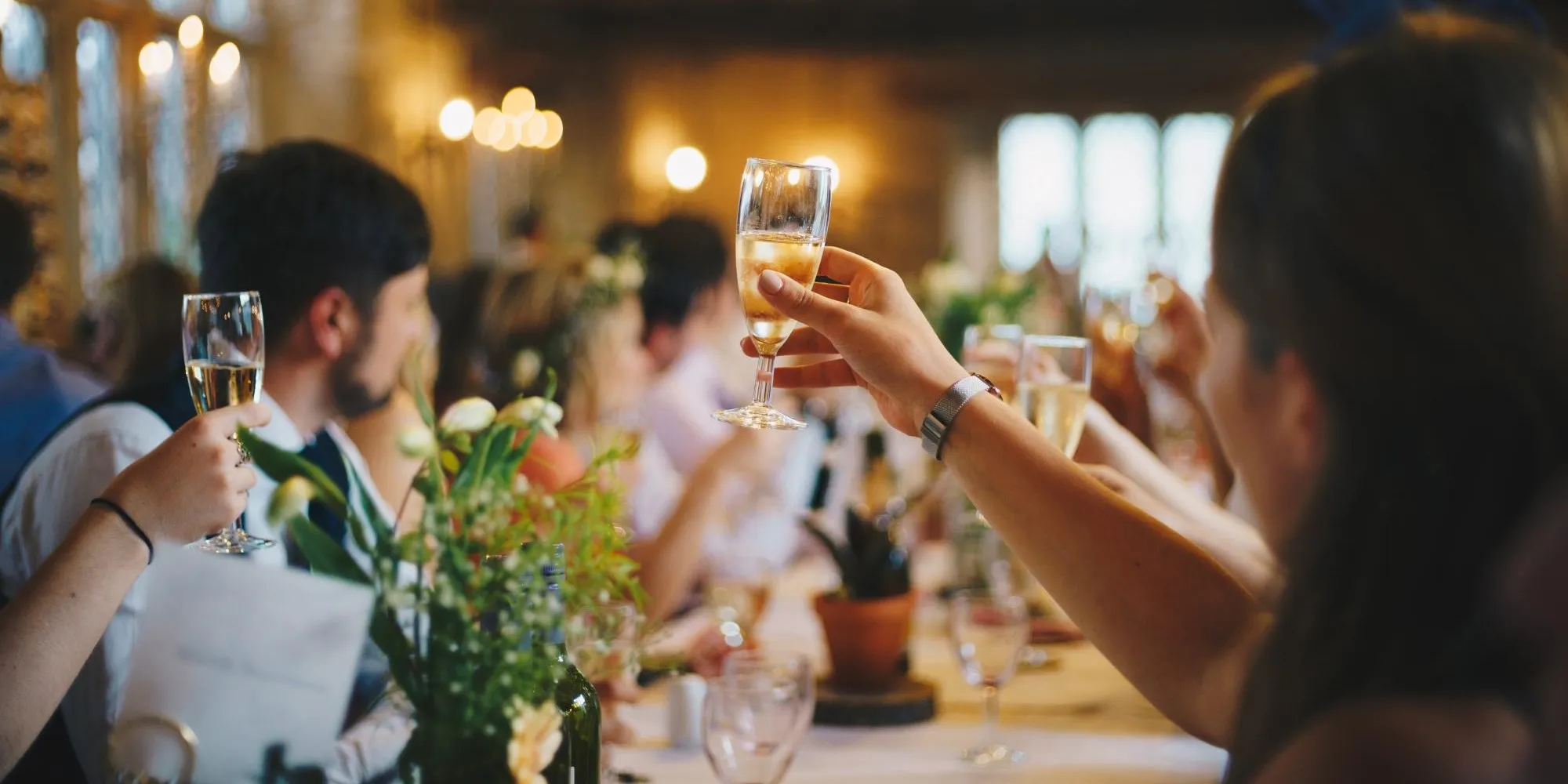 Guests raising champagne glasses at an elegant Palm Springs wedding reception