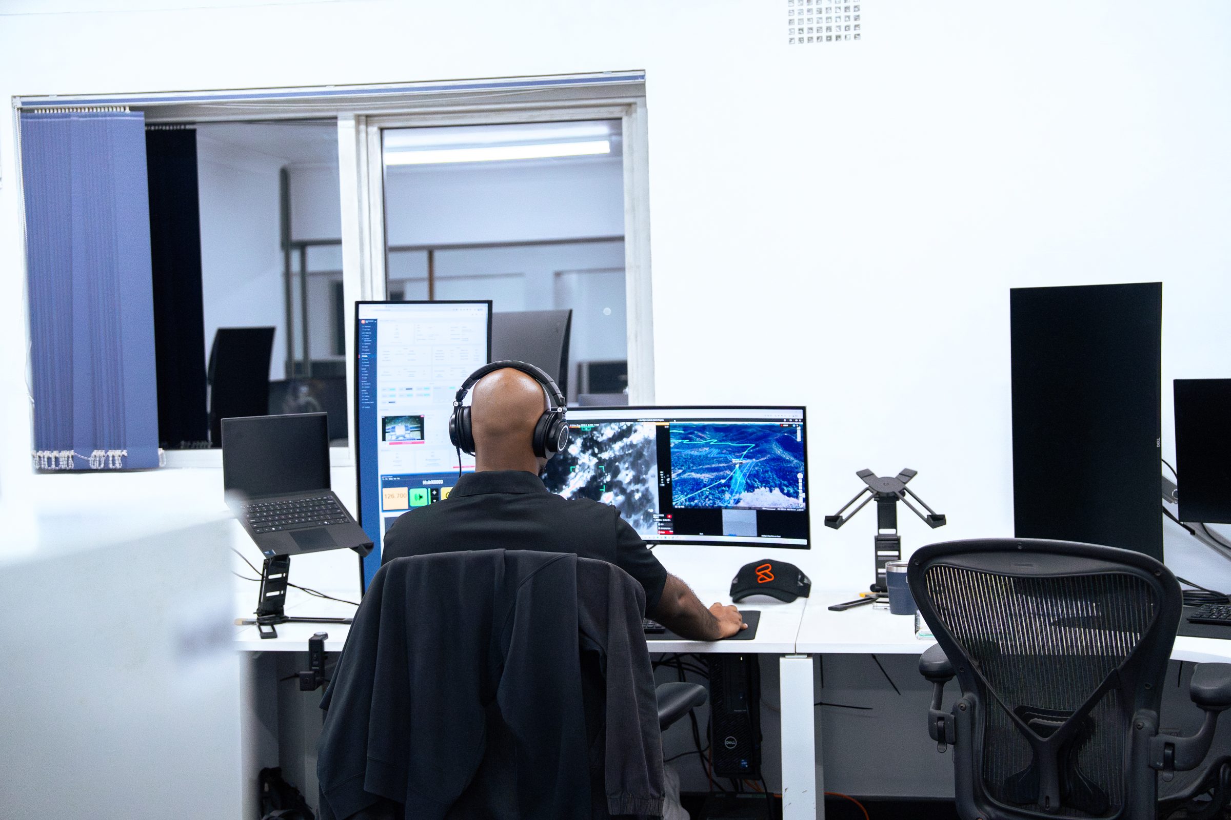 A remote pilot flying a mission in the Remote Operations Centre after hours