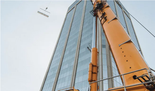 there is a crane that is standing in front of a building