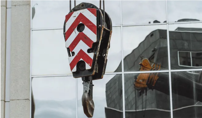 there is a red and white block hanging from a building