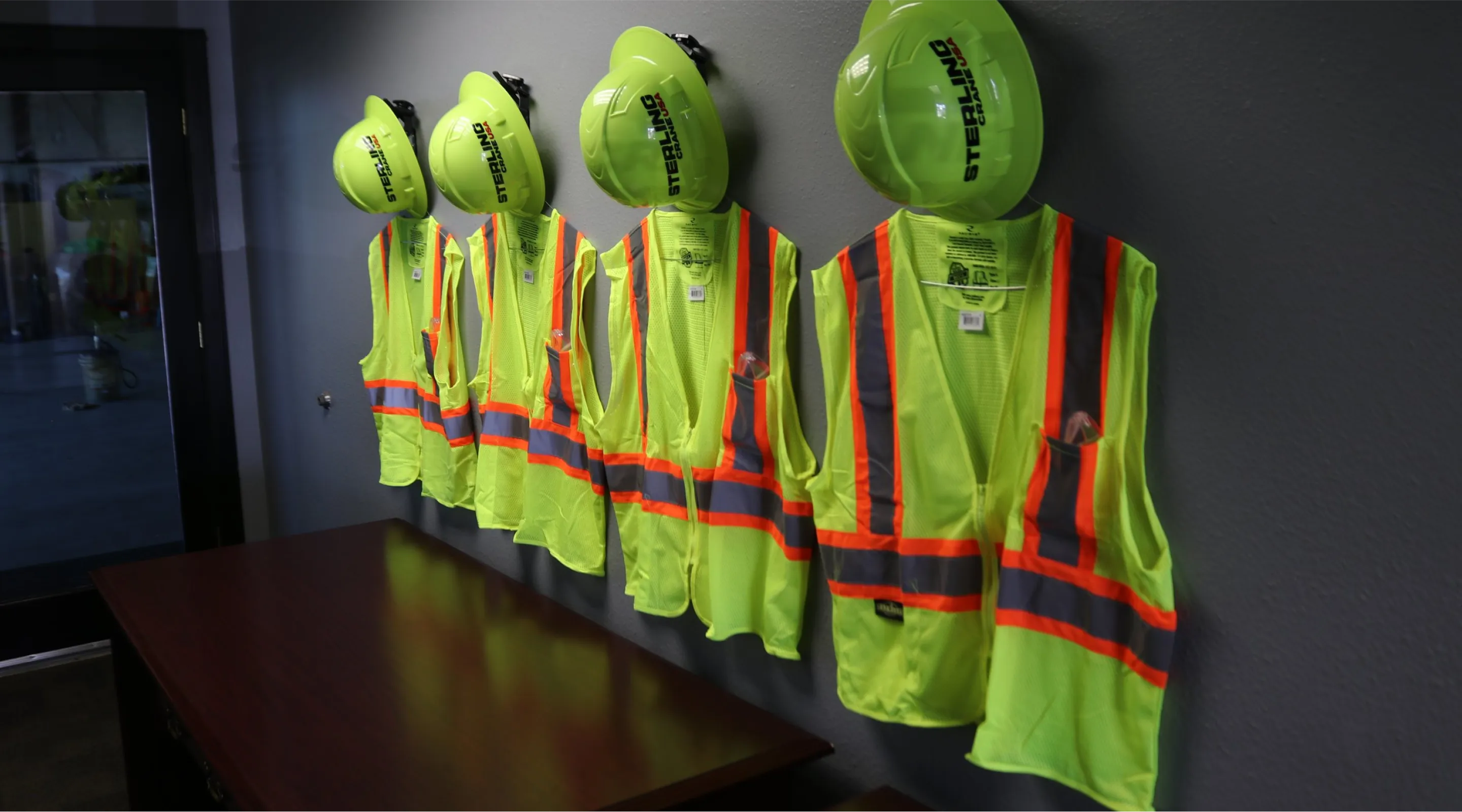there are many safety vests hanging on the wall in a room