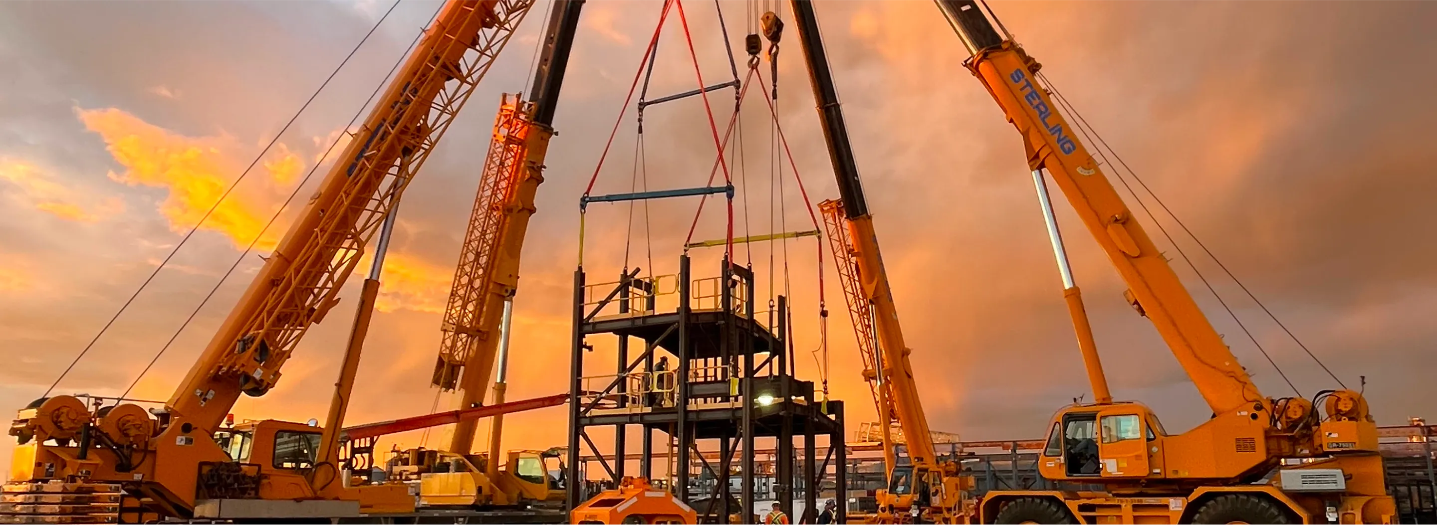 there are many cranes that are being used to lift a large truck